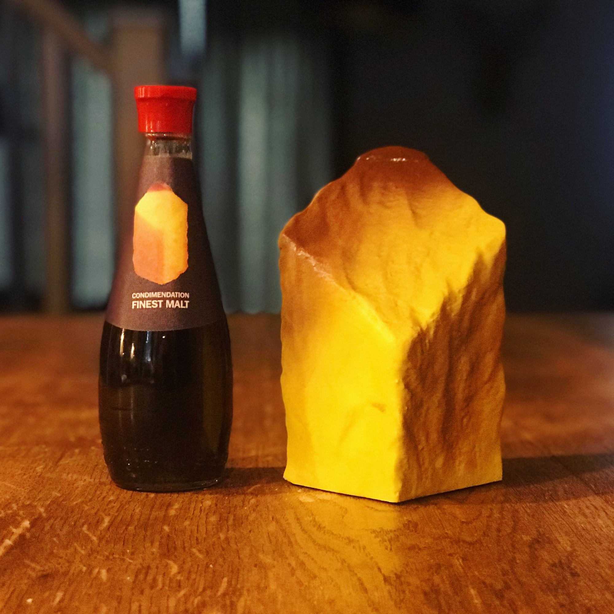 A bottle of vinegar and a french fry