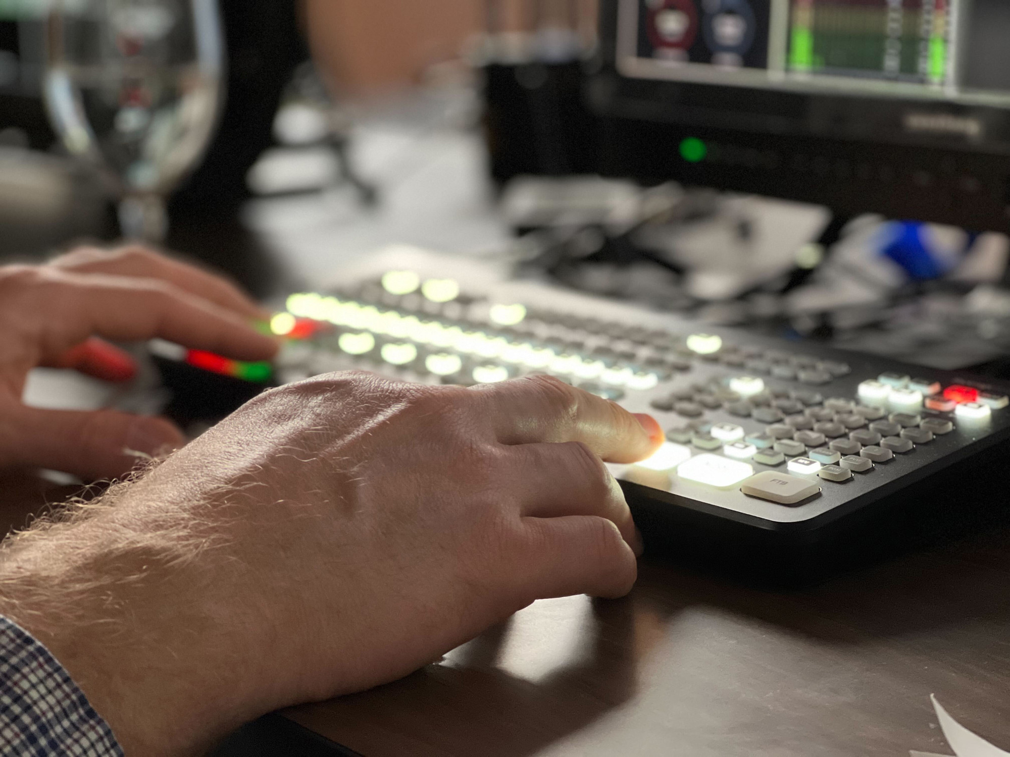A closeup of hands using a keyboard to edit a video