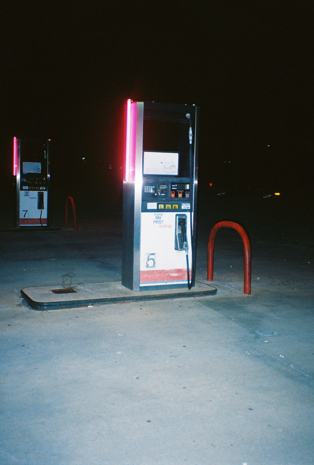 A retro gas pump at night