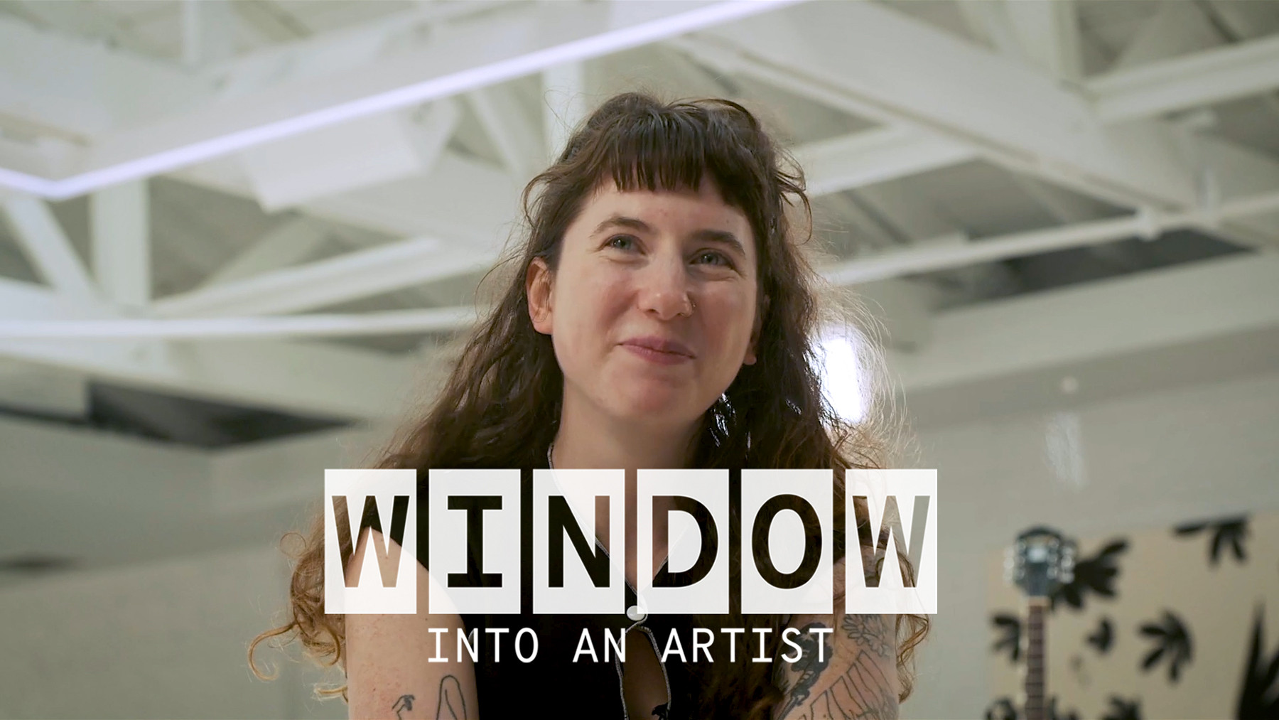 A close up of Karly Hartzman smiling. Text on the image reads ‘Window Into An Artist’.